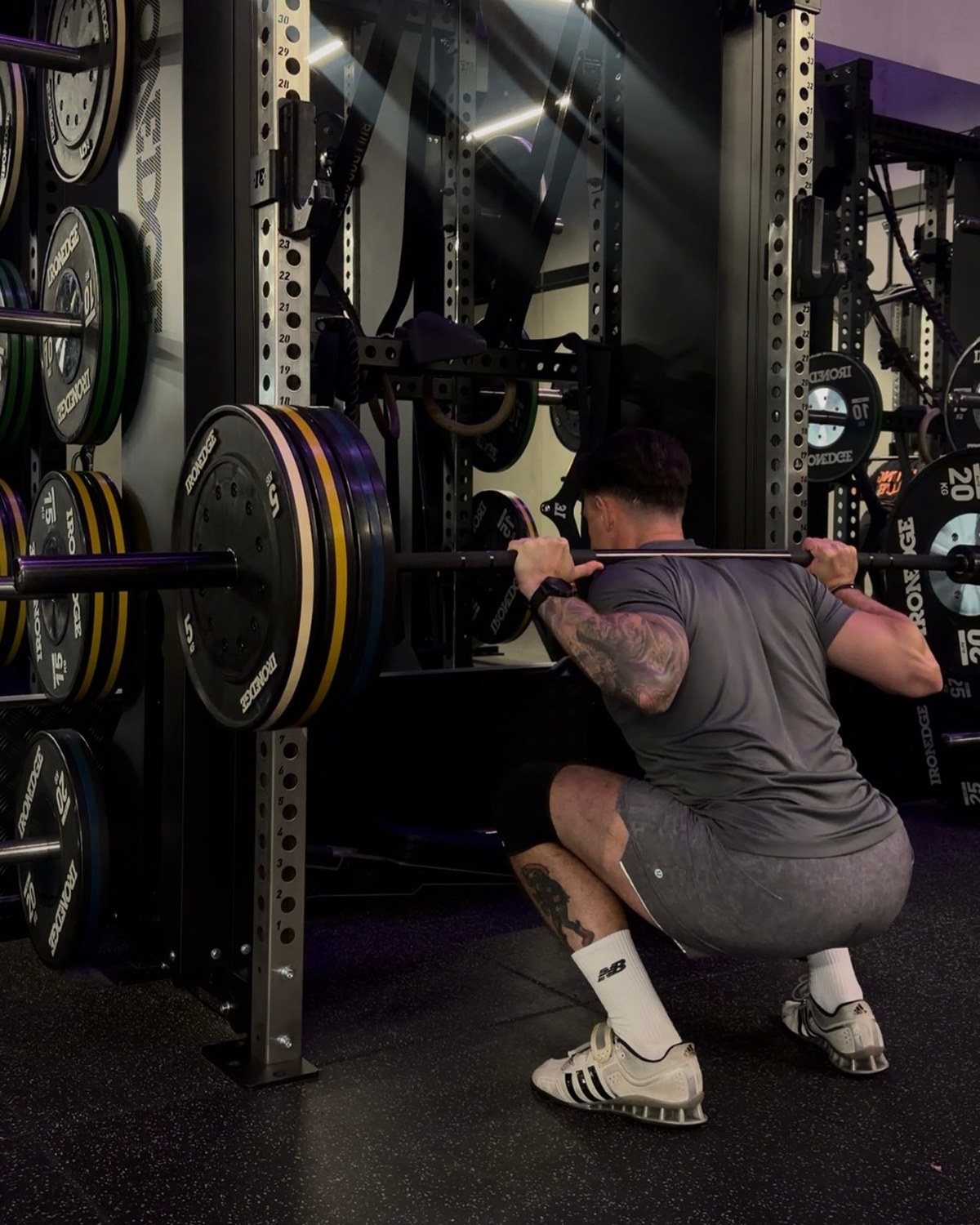 Craig back squatting in the rack at the Injury Active Clinic gym